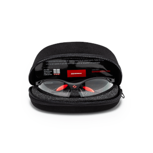 Front view of black sports glasses with red nose pads and orange accents inside a black protective case, showing the "GEARBOX" logo.