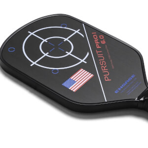 Top-down view of a black pickleball paddle with a target design, American flag, and PURSUIT PRO1 6.0 text.