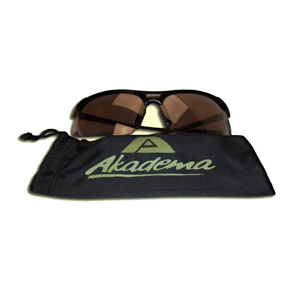 Front view of black sunglasses with brown lenses and a black pouch with the Akadema logo.