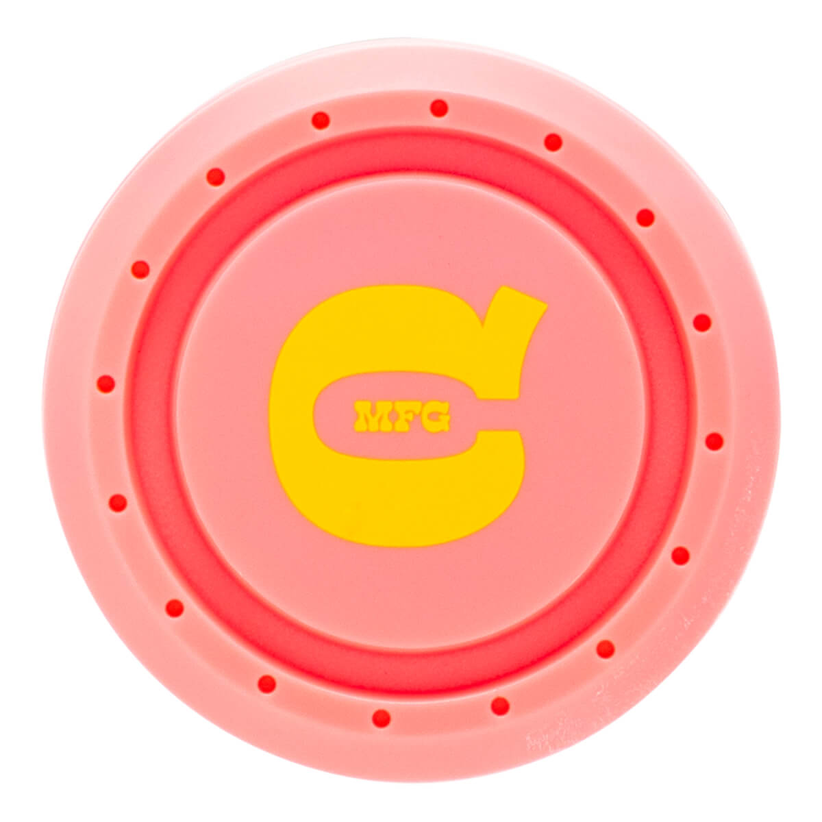 Top-down view of the pink bat knob featuring a yellow stylized "C" logo with "MFG" in the center and a ring of small circular indentations.