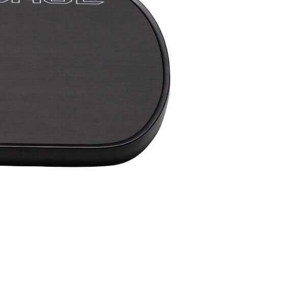 Close-up of top-left corner of a black pickleball paddle with a textured surface and rounded black edge bumper.
