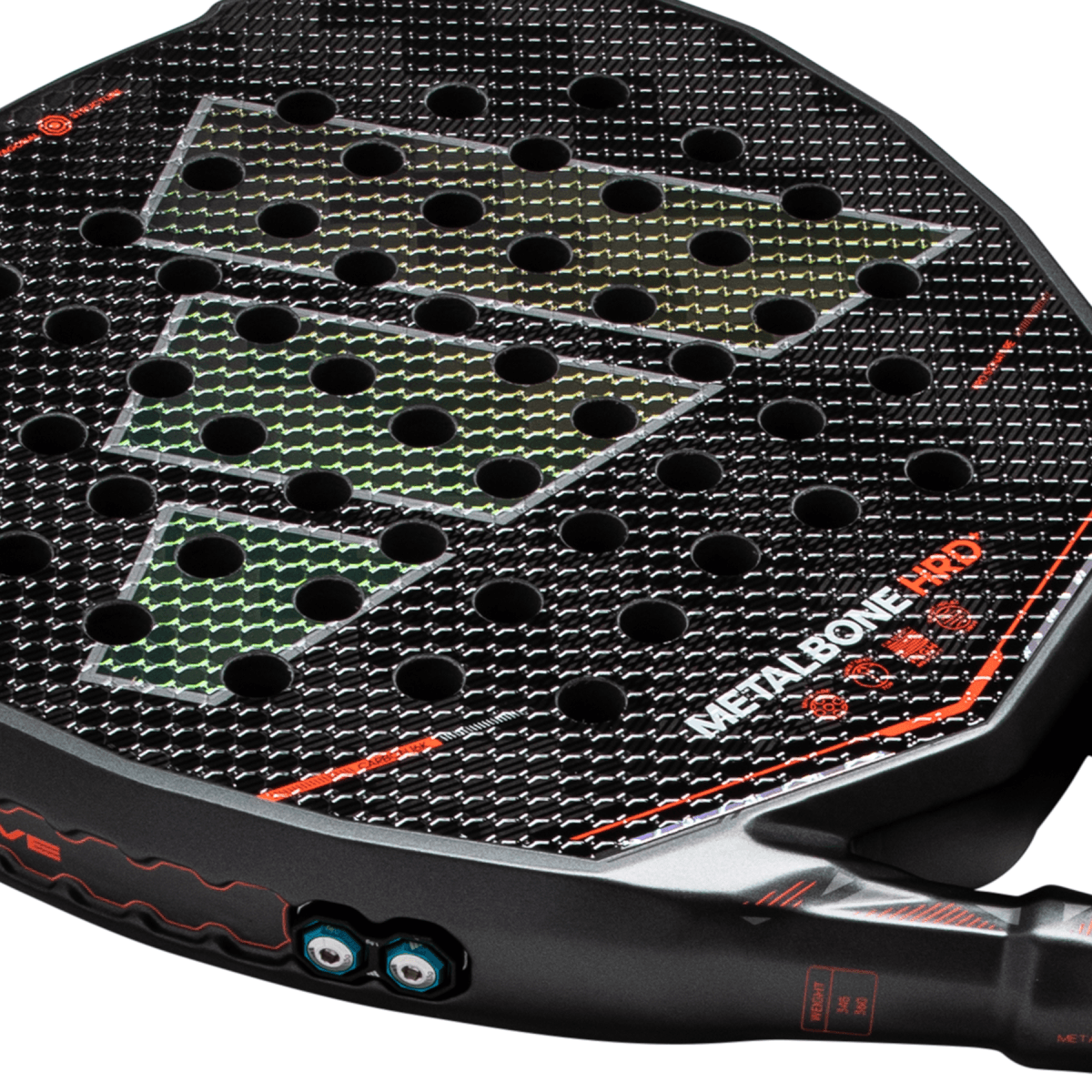 Close-up of a black padel racket face featuring the "METALBONE HRD" text, green diamond patterns, and circular holes.