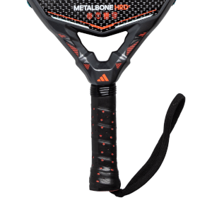 Top-down view of the handle and neck of a black METALBONE HRD racket with orange accents and a wrist strap.
