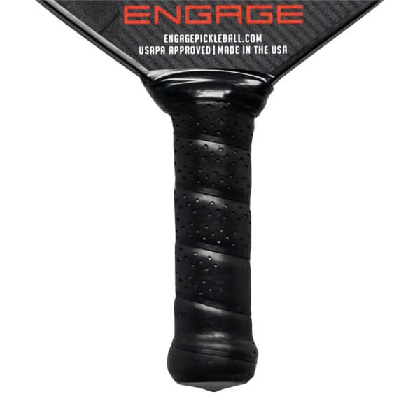 Close-up of a black pickleball paddle grip with spiral texture and perforations, showing Engage branding and USAPA approved text.