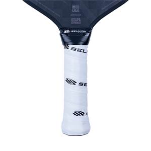 Close-up of a white pickleball paddle grip with black Selkirk branding and USAPA approved text.