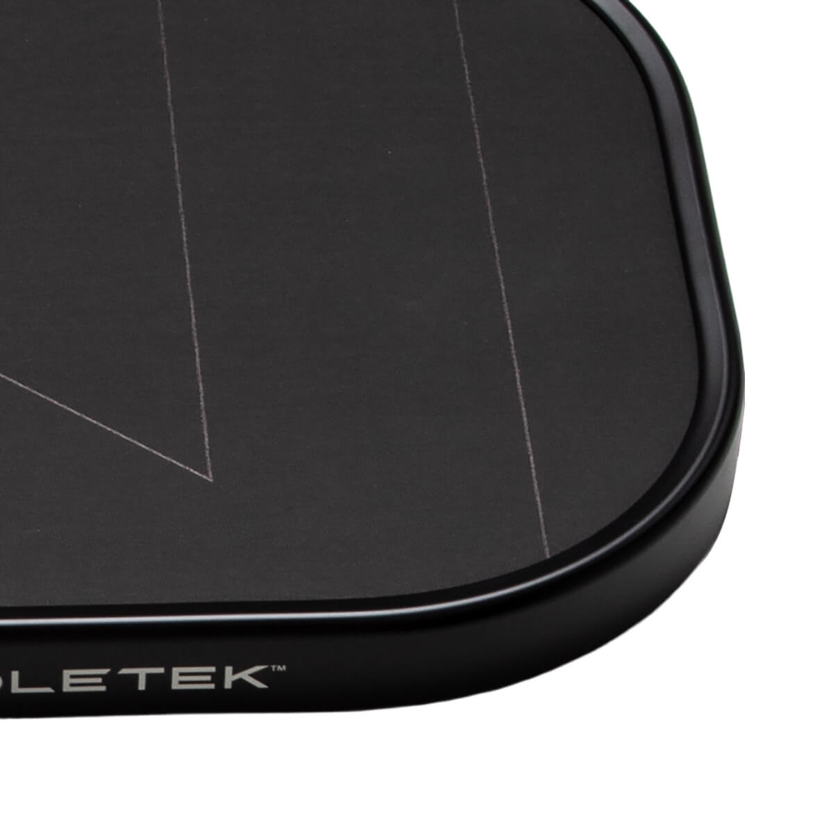 Close-up of a black pickleball paddles bottom right corner with white design lines and PADDLETEK™ branding.
