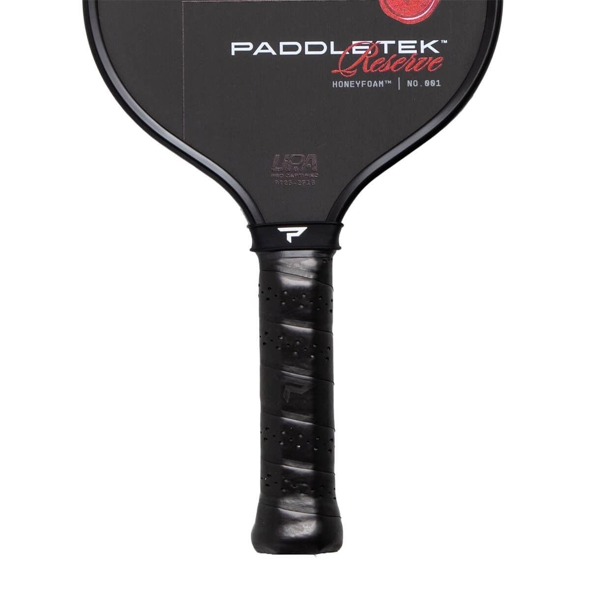 Partial front view of a black Paddletek Reserve pickleball paddle showing its branded face and a perforated black grip.