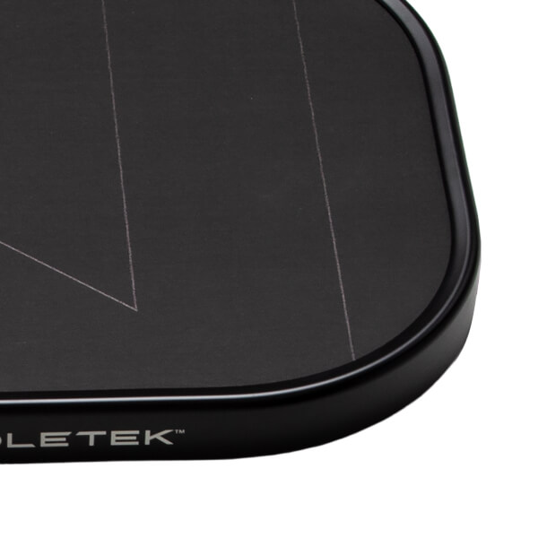 Close-up of a black pickleball paddles bottom right corner with white design lines and PADDLETEK™ branding.