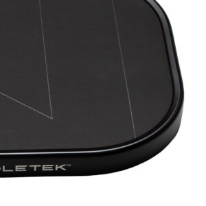 Close-up of a black pickleball paddles bottom right corner with white design lines and PADDLETEK™ branding.