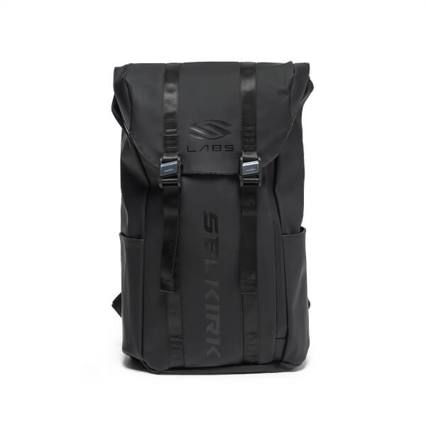 Front view of an all-black backpack with two vertical buckled straps, featuring the LABS logo on the top flap and the word SELKIRK embossed vertically down the center.