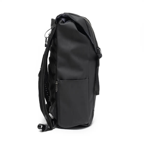 Side view of the matte black Project Prestige backpack showing the padded straps, zippered side pocket, and fold-over top.