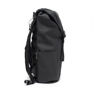 Side view of the matte black Project Prestige backpack showing the padded straps, zippered side pocket, and fold-over top.