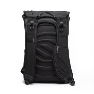 Back view of the black backpack featuring a contoured, padded back panel, adjustable shoulder straps with gear hooks, and a small zippered pocket on the right strap.
