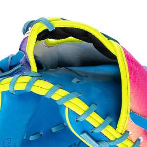 Close-up of the wrist opening and heel featuring bright yellow binding, teal lacing, blue leather, and a pink scale-textured pattern on the shell.