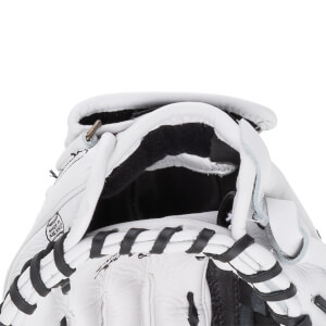 Close-up view of a white baseball glove's wrist opening featuring black laces and a stamp that reads MADE IN MEXICO.
