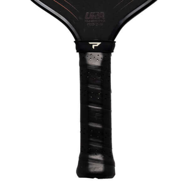 Close-up of a black pickleball paddle grip with a white 'P' logo and 'USA' text visible.