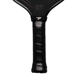 Close-up of a black pickleball paddle grip with a white 'P' logo and 'USA' text visible.