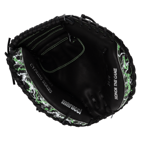 Front view of a black catcher's mitt featuring a green camo pattern on the edges and silver text that reads marucci, Cypress Series, and Honor the Game.