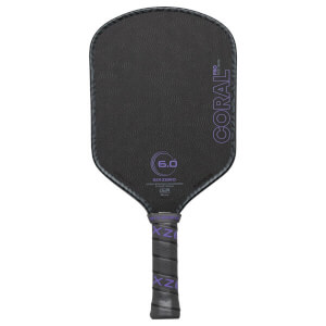 Front view of a black pickleball paddle with purple "CORAL PRO", "6.0", and "SIXZERO" branding.
