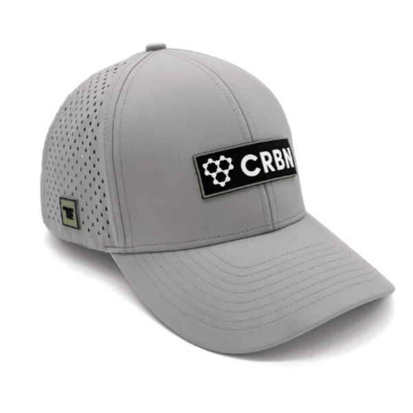 Front corner view of a grey baseball cap with a black patch featuring the word "CRBN" and a molecule graphic.