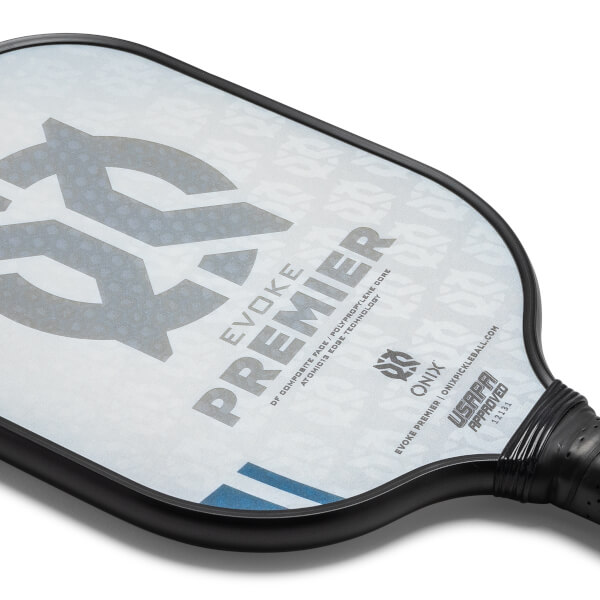 Corner view of a white pickleball paddle with EVOKE PREMIER text and USAPA approved stamp.