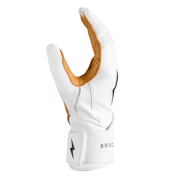 Side view of a white batting glove with tan leather accents, showing the word "BRUC" on the wrist strap.