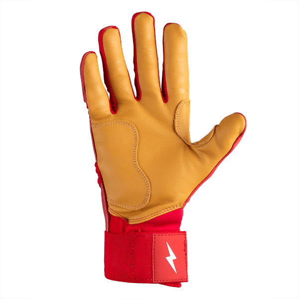 Palms-up view of a tan leather glove with red trim, showing stitched seams and a red wrist strap with a white lightning bolt logo.