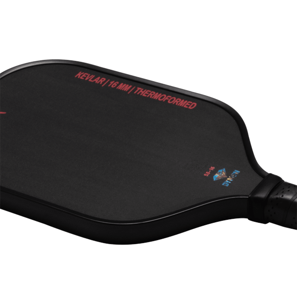 Corner view of a black Dymon Mayhem paddle, showing "KEVLAR | 16 MM | THERMOFORMED" and the Dymon logo.