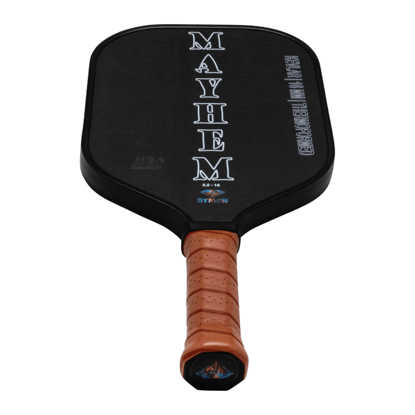 Top-down view of a black Dymon Mayhem paddle with a brown grip, showing "MAYHEM" vertically and "DYMON" logo.