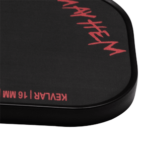 Corner view of the Dymon Mayhem paddle showing red "MAYHEM" text and "KEVLAR | 16 MM" text.
