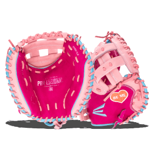 Close-up of two pink baseball gloves with light blue lacing, one interior showing "PROFESSIONAL COLLECTION" and an orange heart with "BE ME".