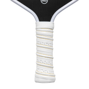 Close-up of a white pickleball paddle grip with yellow trim and black perforations.