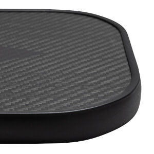 Close-up of a black pickleball paddle with a carbon fiber surface and black edge.
