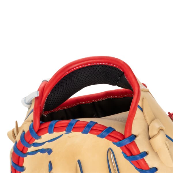 Close-up view of the top of a tan baseball glove, showing red binding and blue lacing.