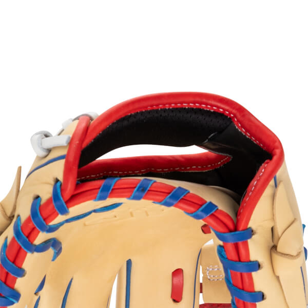 Close-up view of the heel of a tan leather baseball glove with red lacing and a black interior.