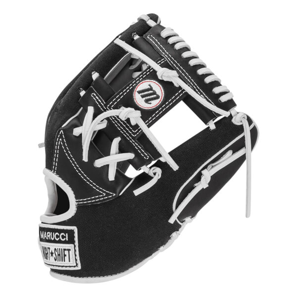 Angled front view of a black baseball glove with white laces, featuring a circular M logo on the web and a wrist patch with the words MARUCCI and NIGHT SHIFT.
