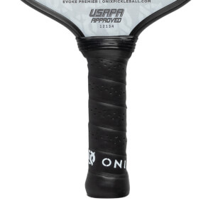 Close-up of a black pickleball paddle grip with perforated texture and white ONIX logo.