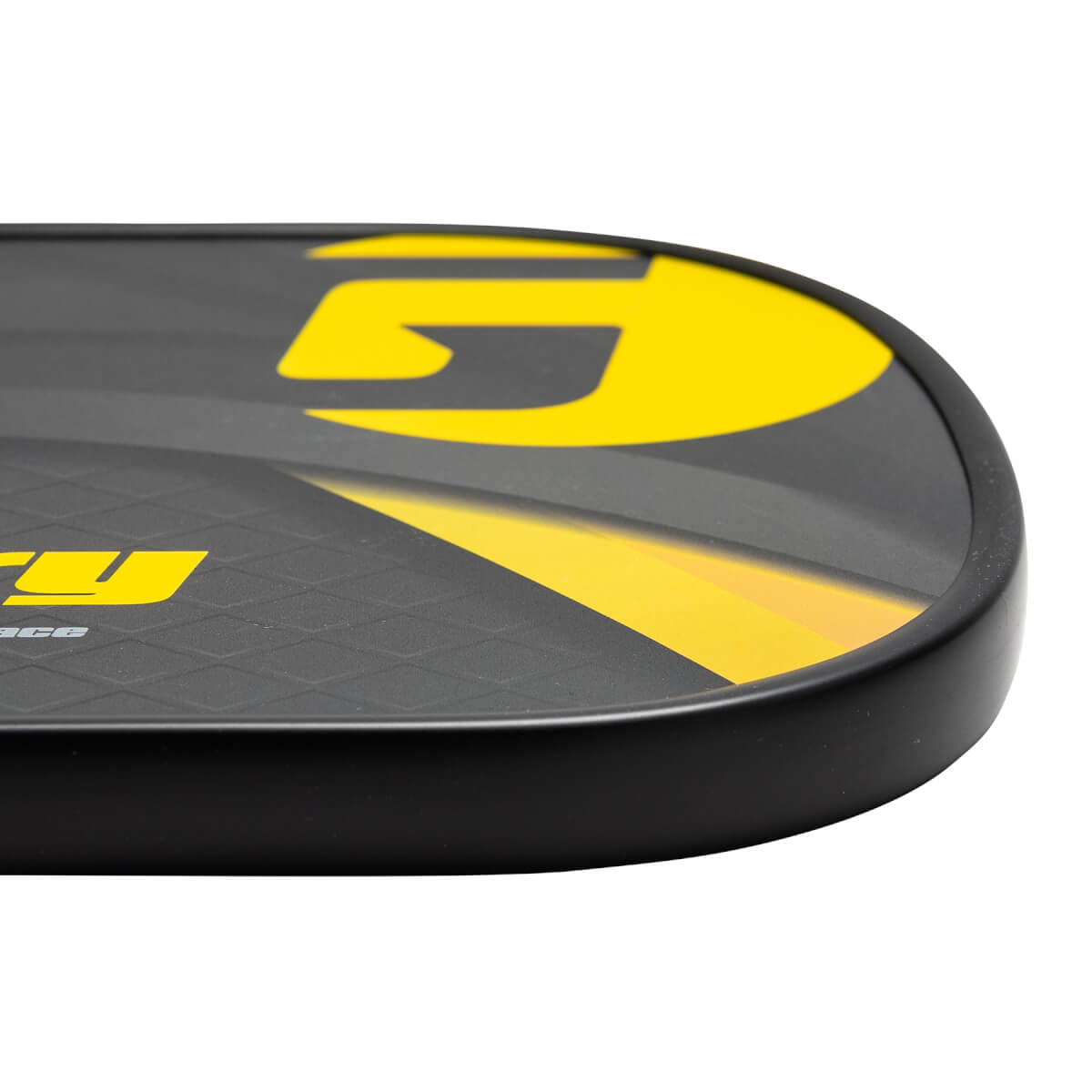 Corner view of a black pickleball paddle with yellow GAMMA logo and textured surface.