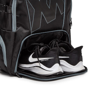 Close-up of a black backpack shoe compartment with two black Nike running shoes with white swooshes and zoom | nlereact text.