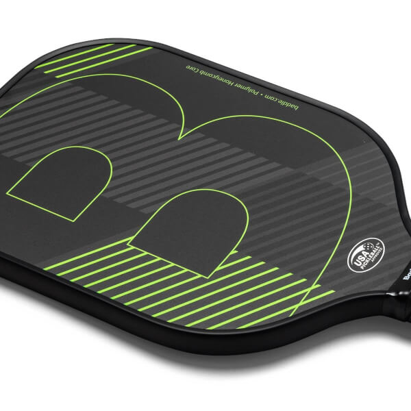 Top-down view of a black pickleball paddle with a large green B logo, diagonal stripes, and USA Pickleball Approved stamp.