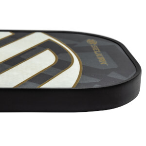 Side view of a black pickleball paddle with white and gold curved lines and Selkirk branding.