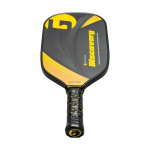 Top-down view of a black pickleball paddle with yellow accents, Discovery text, and a textured grip.