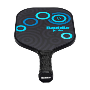 Front view of a black Baddle Junior pickleball paddle with blue concentric circles and textured grip.