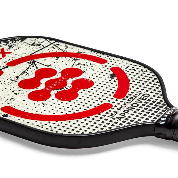 Corner view of a white pickleball paddle with red abstract shapes, ARMOUR text, and USA PICKLEBALL APPROVED text.