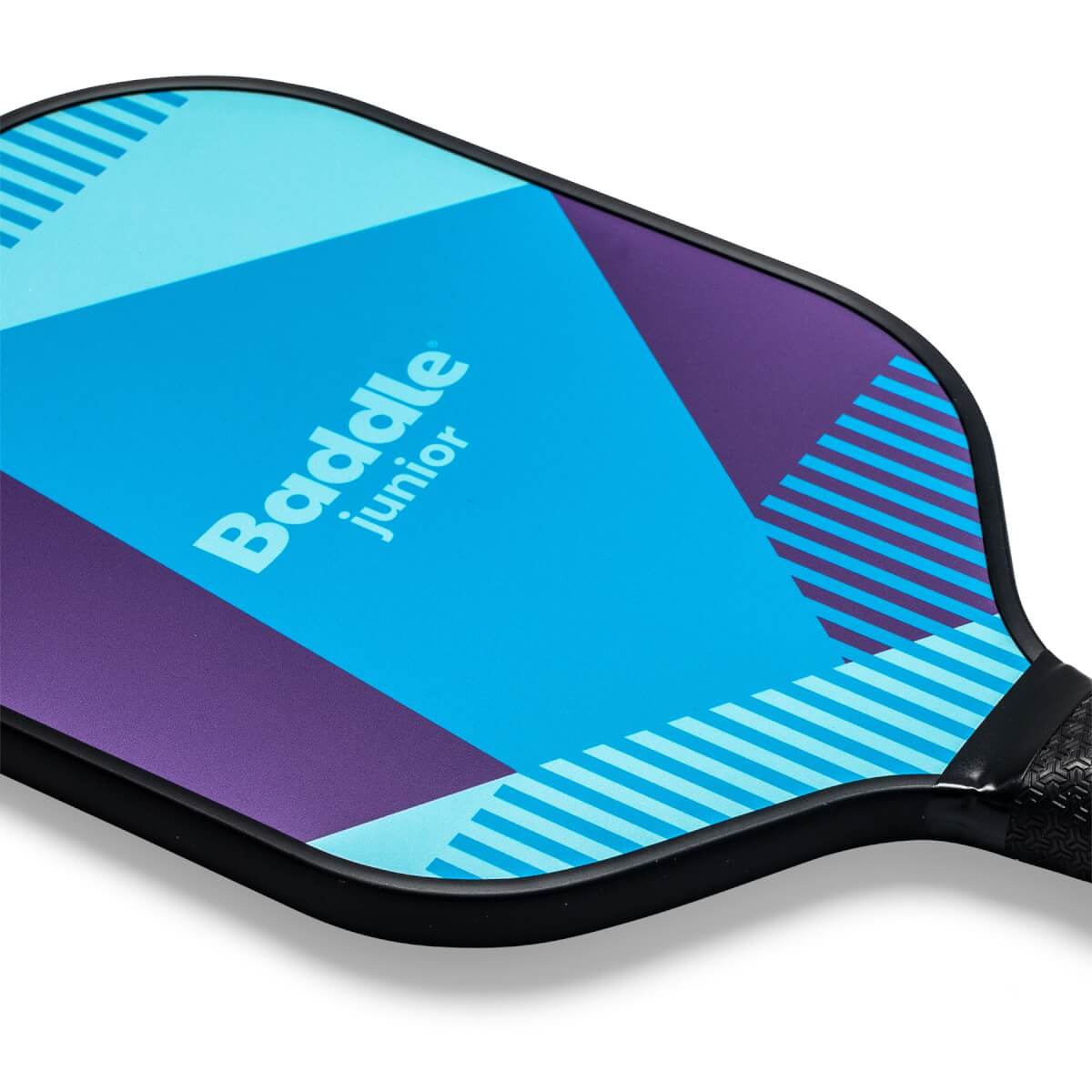 Corner view of a blue and purple Baddle Junior pickleball paddle with geometric patterns and a black grip.