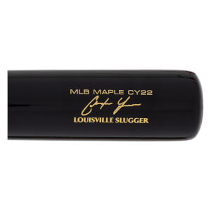 Close-up side view of a black baseball bat with gold MLB MAPLE CY22, Christian Yelich signature, and Louisville Slugger branding.
