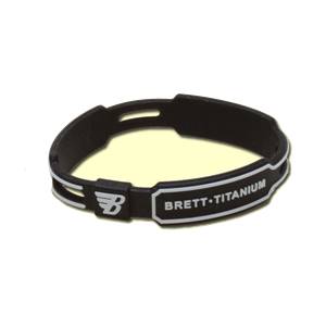 Close-up of a black bracelet with white B logo and BRETT•TITANIUM text.