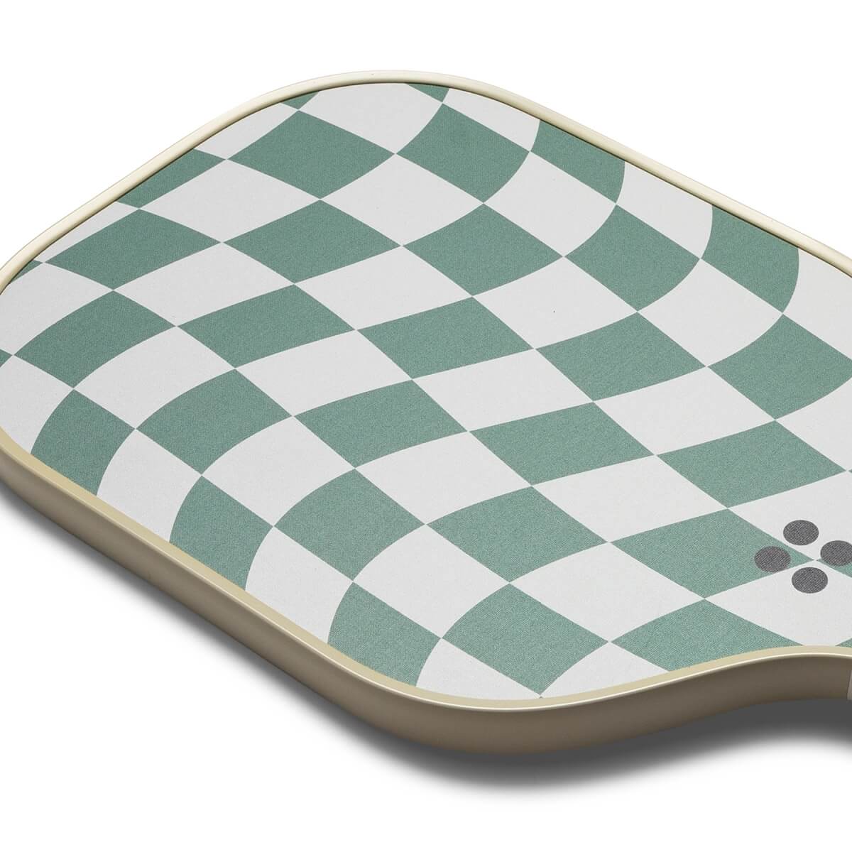 Top-down view of a green and white pickleball paddle with a checkered pattern and four grey dots.