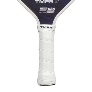 Close-up of a white pickleball paddle grip with TMPR branding and a USA Pickleball Approved logo.