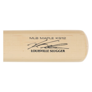 Close-up of a natural wood baseball bat with MLB MAPLE KS12, a signature, and LOUISVILLE SLUGGER printed in black.